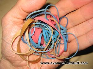 A tangle of multicolored exudate rubber bands regarding the hand of a hand.